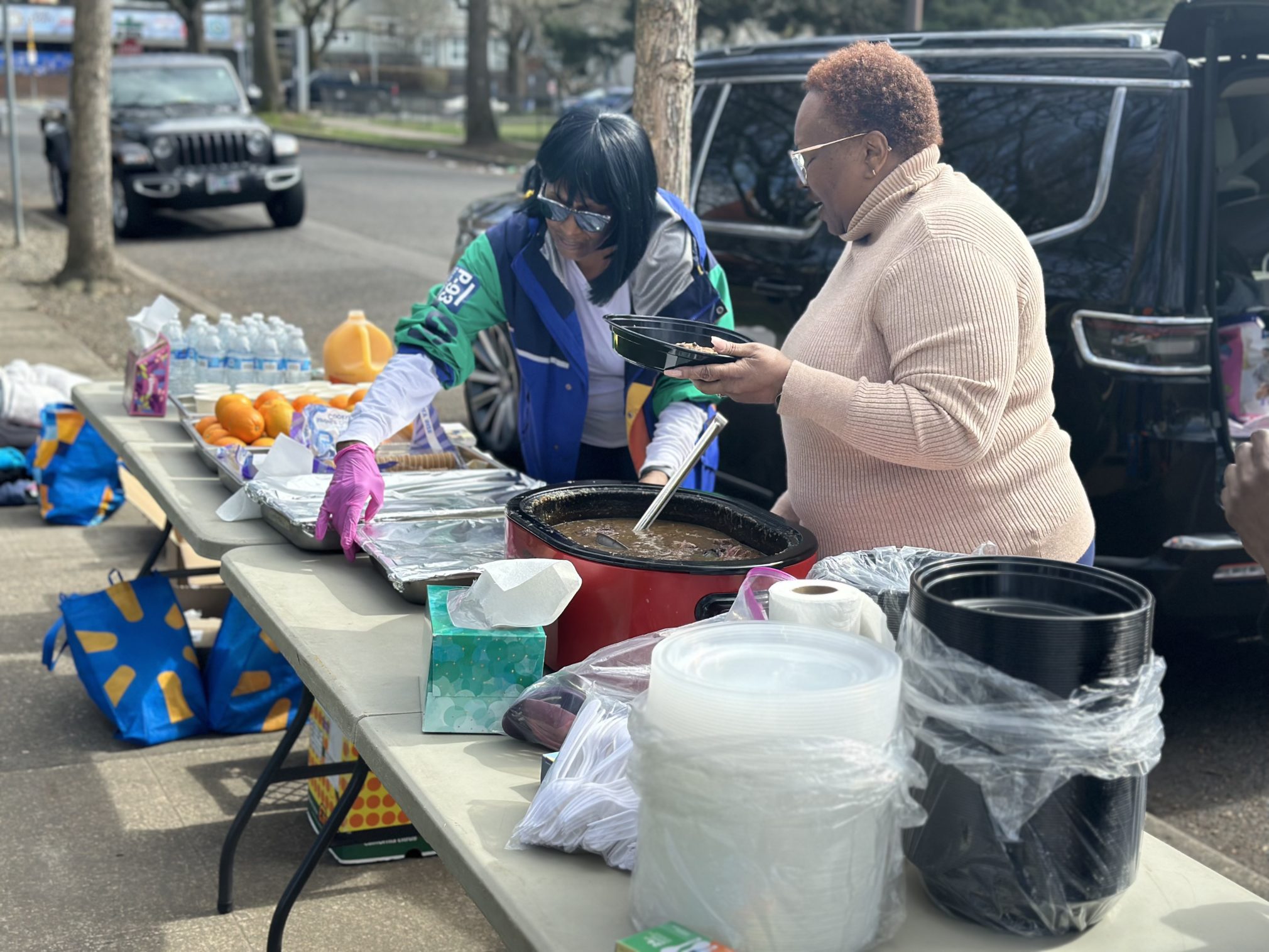 sister Gail Wilson and sister Bedell serving up hot food